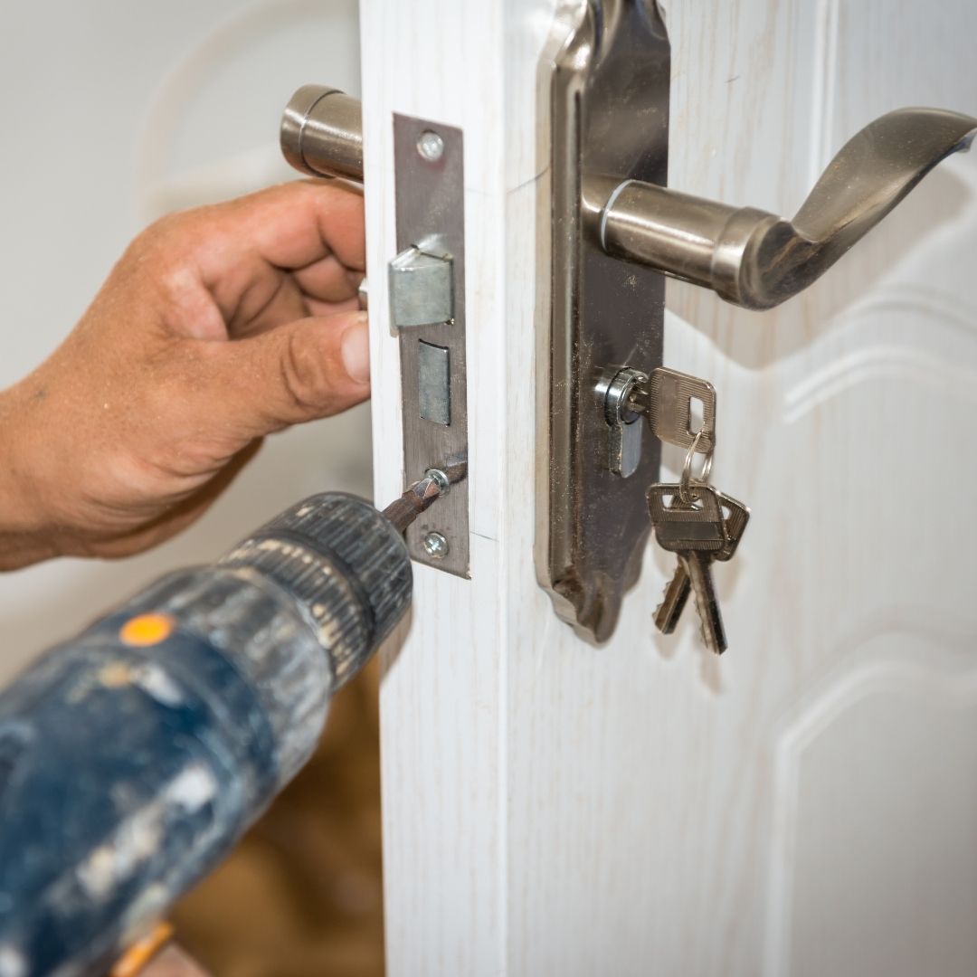 Locksmith fixing a door lock in Harrow
